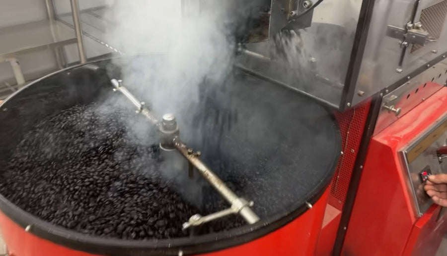 Fresh-roasted beans tumbling in the cooling tray of Ocana's red roaster